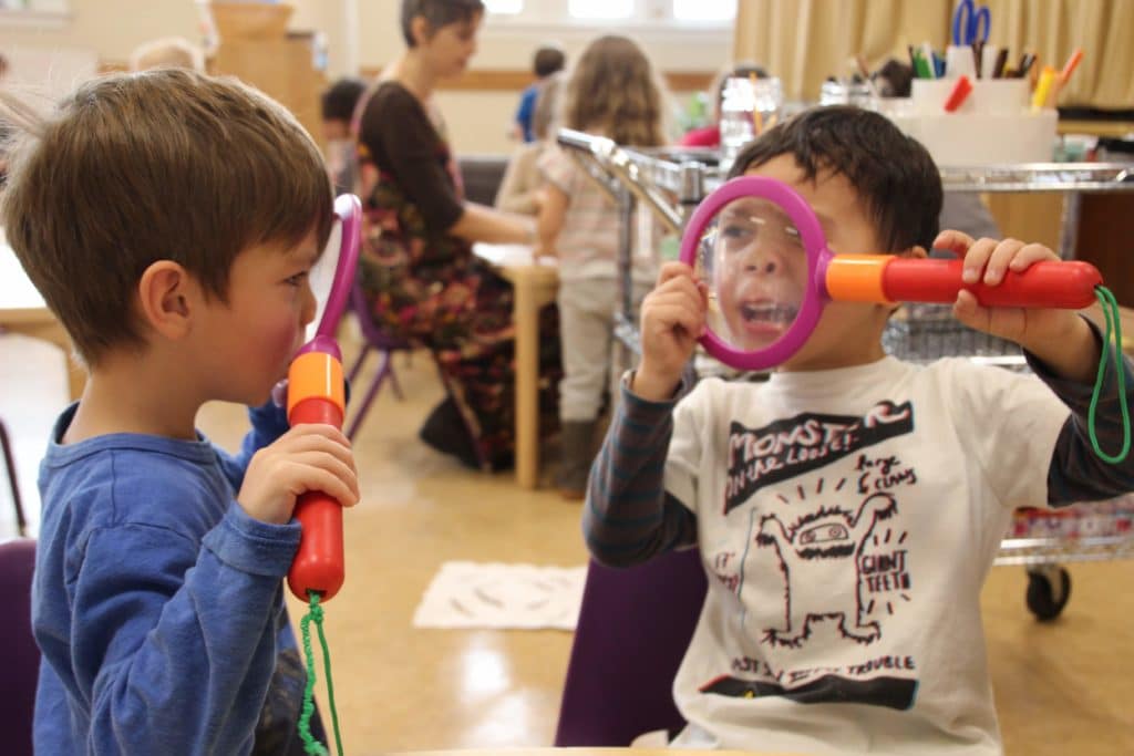 Two children are playing with a toy microphone.